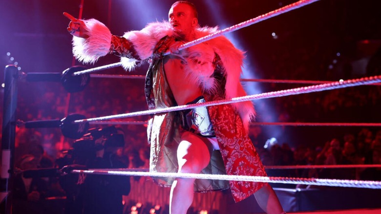 Former NXT Champion Ilja Dragunov wears the title around his waist and points to the crowd during an episode of "WWE NXT" programming.