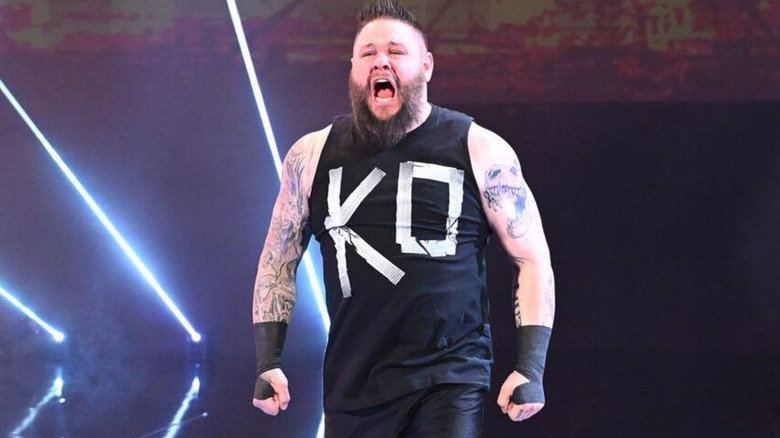 Kevin Owens poses on the stage during his entrance before a match on WWE progrmaming.