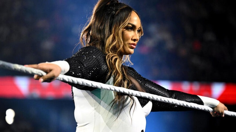 Nia Jax leans on the ring ropes before a match on "WWE Raw."