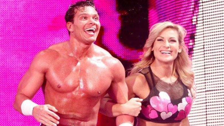 Tyson Kidd and Natalya, linked arm in arm, head out to the ring for a match on WWE programming.