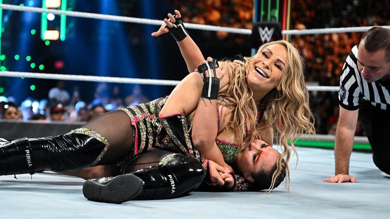 Nattie locking Ronda Rousey into a Submission during a WWE clash.