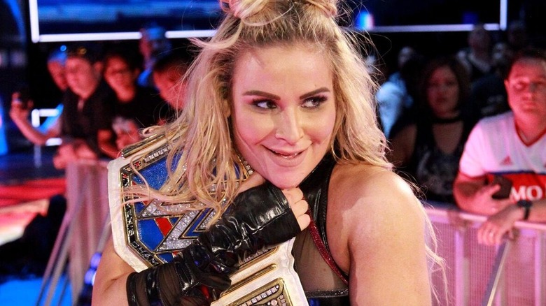 Nattie clutches her WWE SmackDown Women's Championship after a successful defense against Naomi