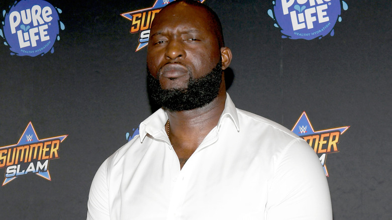 WWE star Omos wearing a white shirt