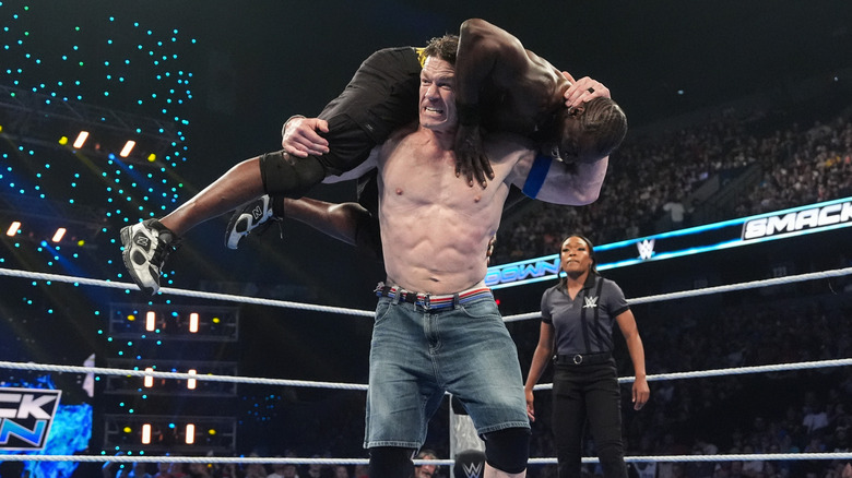 John Cena hoisting R-Truth on top of his shoulders to hit the Attitude Adjustment, during their Singles match on 
