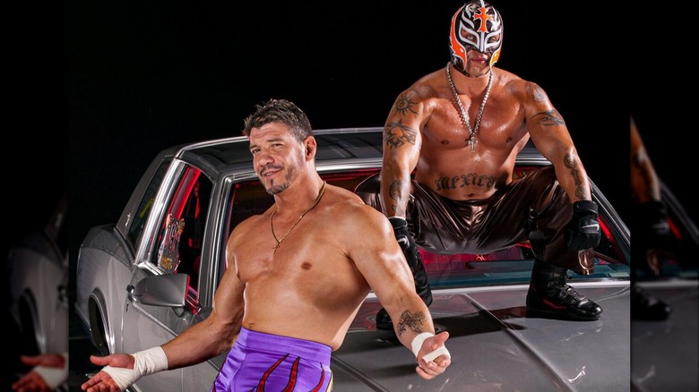 Eddie Guerrero and Rey Mysterio posing with one of his lowriders for a promotional shoot.