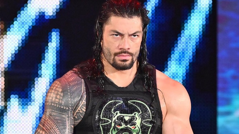 Roman Reigns glowers as he makes his entrance.