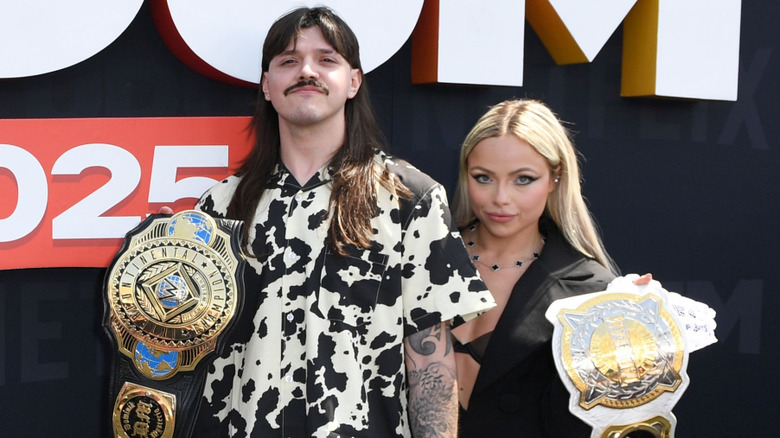 Dominik Mysterio and Liv Morgan standing beside one another