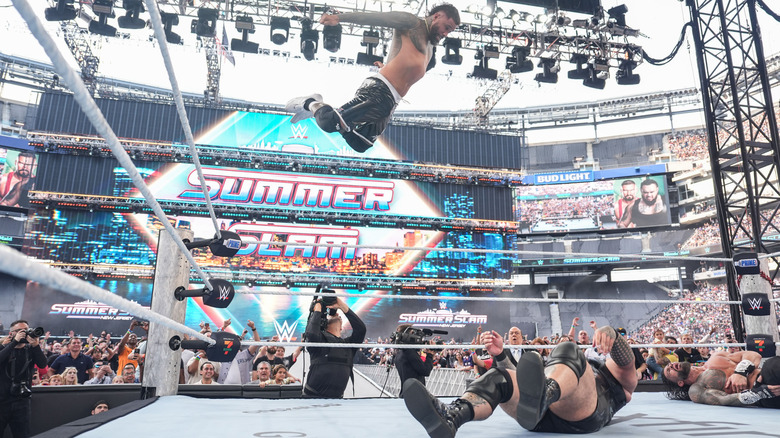 Jey about to land an Uso Splash on Reed