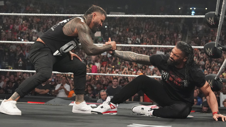 Jey Uso helps up Roman Reigns on an episode of "WWE Raw."