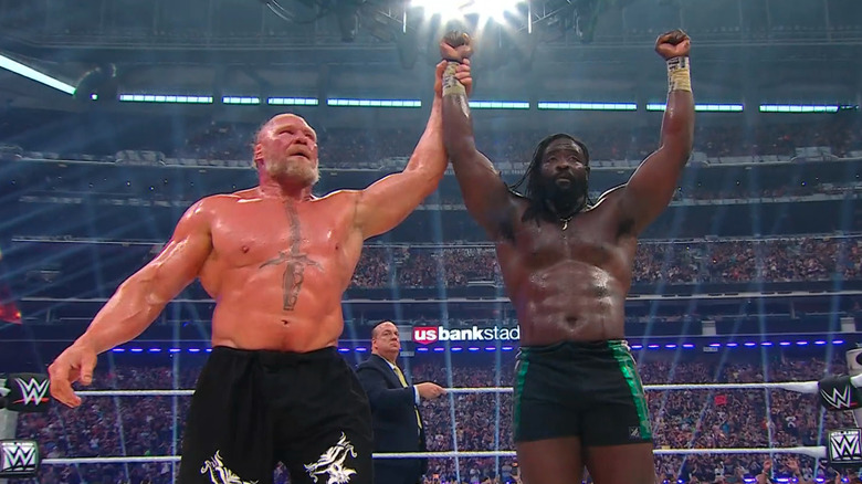 Brock Lesnar raises Oba Femi's arm at WWE SummerSlam