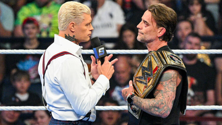 Cody Rhodes and CM Punk looking at one another