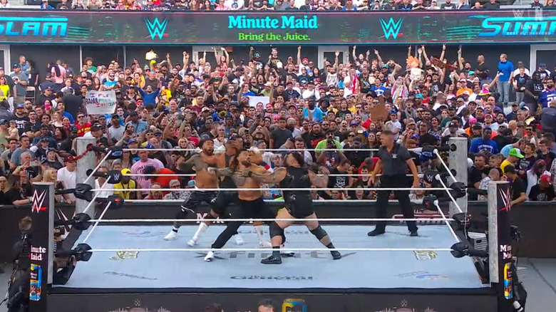 All four men brawling with one another in the ring