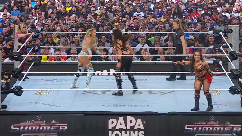 Flair and Rodriguez brawling in the ring as Bliss and Perez stand on the apron