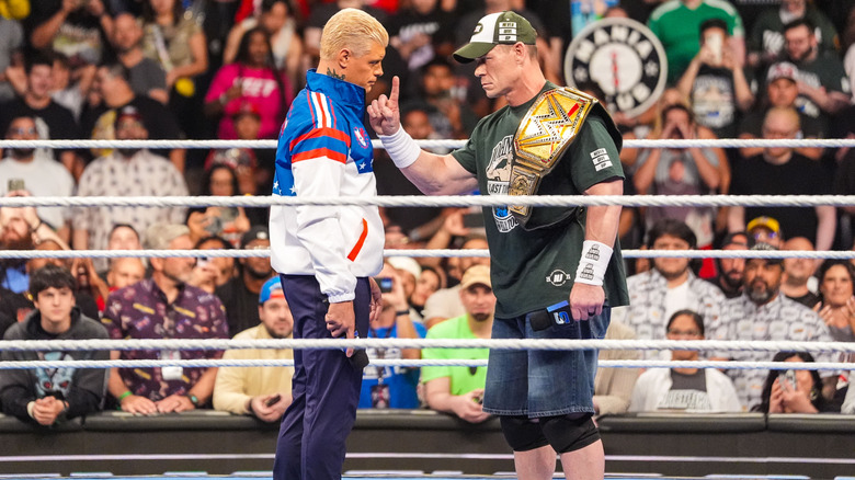 Rhodes and Cena staring one another down in the ring