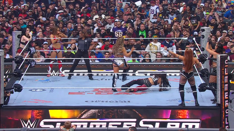 All six women inside and around the ring