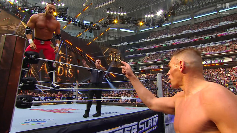 GUNTHER pointing at Aldis from the outside of the ring