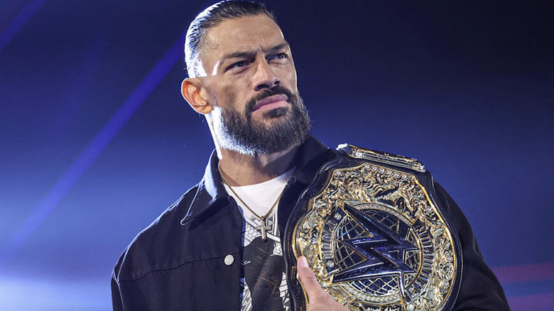 Reigns with his World Heavyweight Championship belt on his shoulder