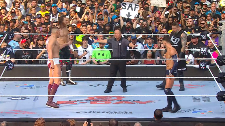 All four men staring down one another in the ring