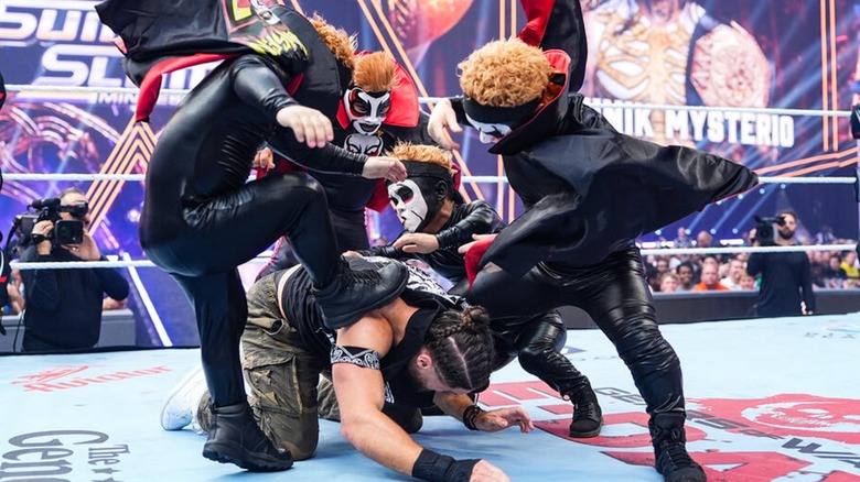 The Minihausens all attacking JD McDonagh during SummerSlam 2026.