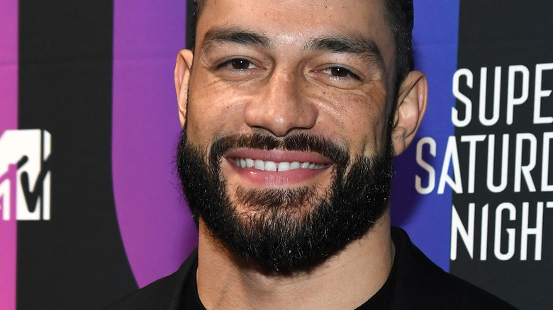 Roman Reigns smiles at a press event 