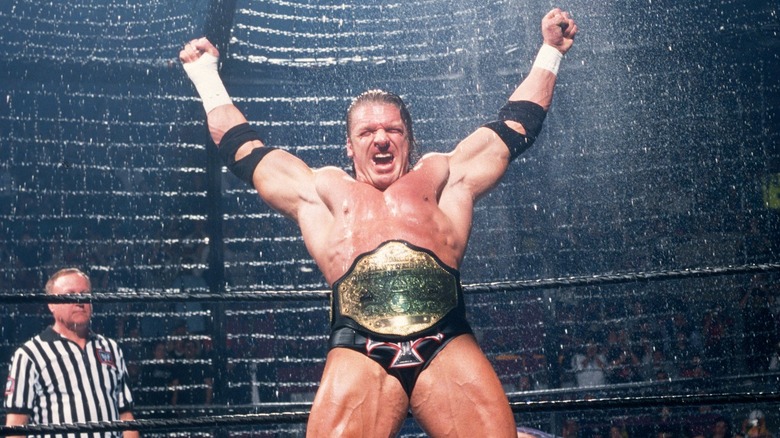 Triple H makes an entrance with the World Heavyweight Title