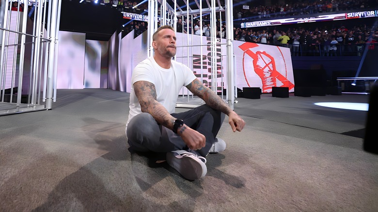 CM Punk sitting cross-legged