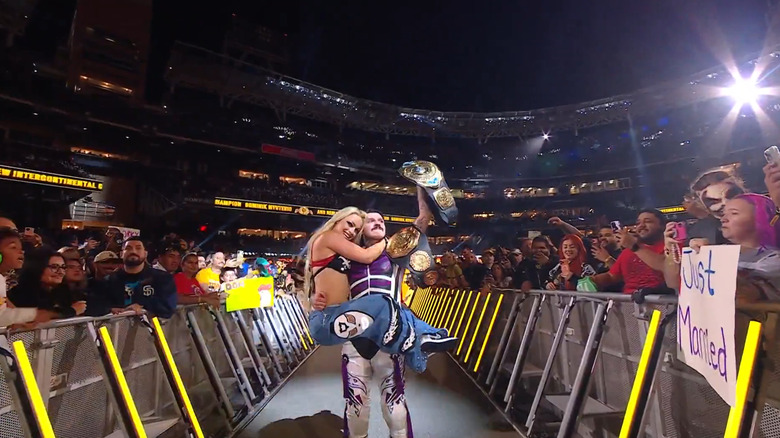 Dominik Mysterio and Liv Morgan celebrate
