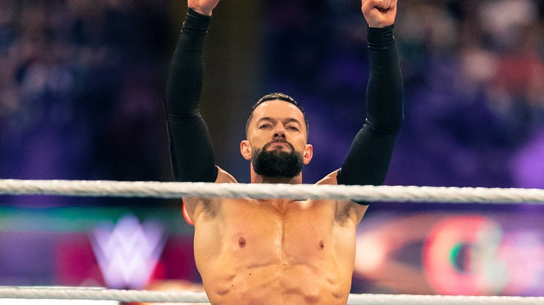 Finn Balor posing inside the ring 