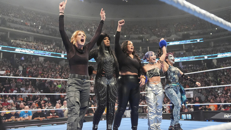 Lynch, Legend, Jax, Sane, and Asuka in the ring with their hands raised