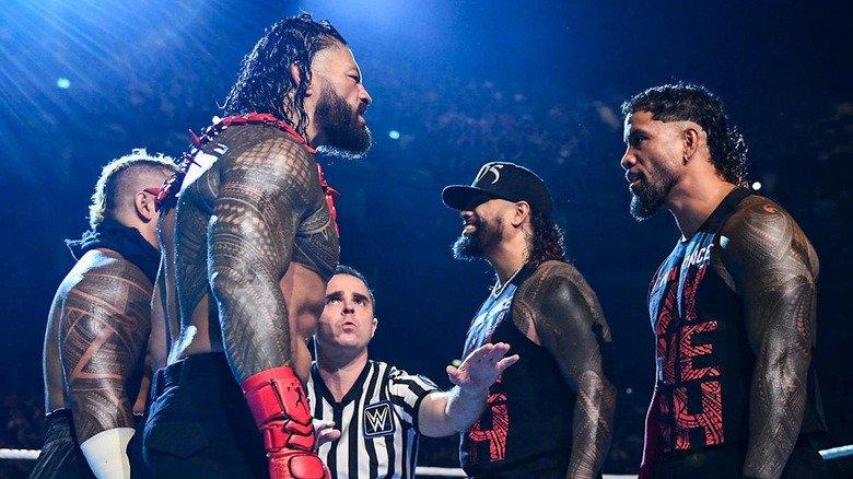 Roman Reigns and Solo Sikoa stare down The Usos