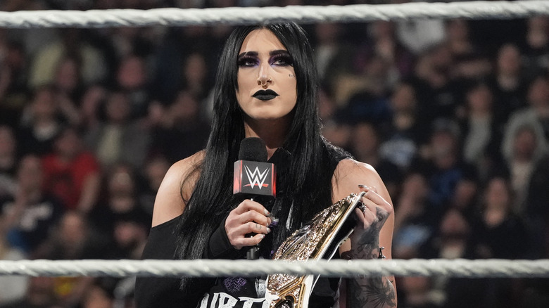 Rhea Ripley holding WWE Women's World Title belt in the ring.