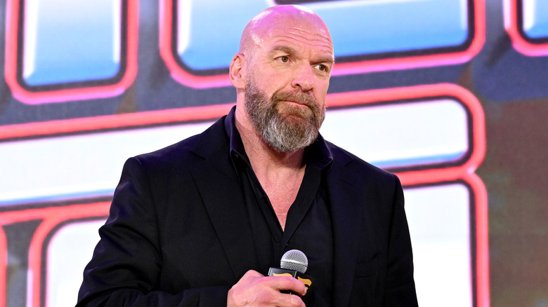 Paul Levesque with a microphone