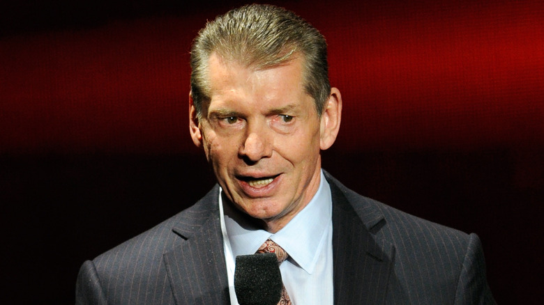 Vince McMahon talking with a microphone