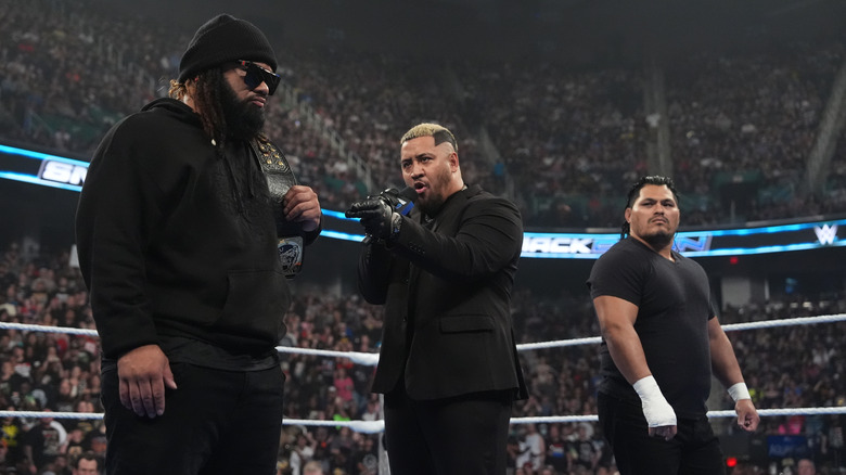 Solo Sikoa speaks to Jacob Fatu while JC Mateo looks on