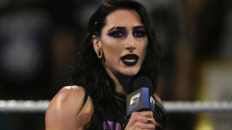 Rhea Ripley holding a microphone