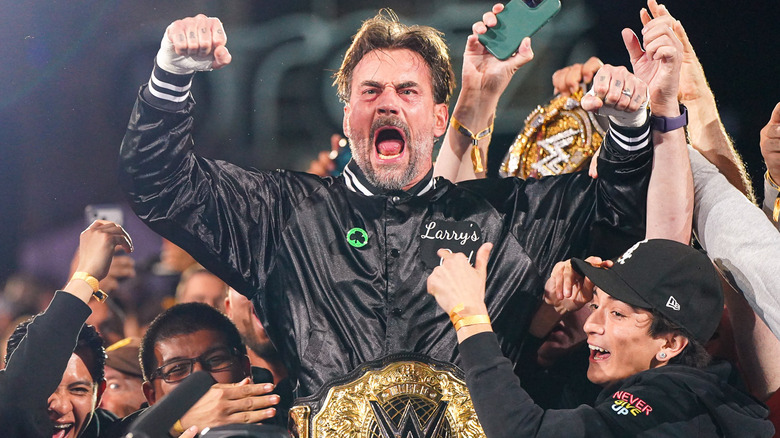 CM Punk celebrating in a crowd