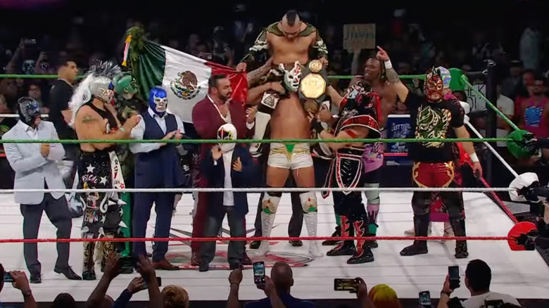 AAA luchadores celebrate in the ring after El Hijo del Vikingo retained the Mega Championship at WWE's Worlds Collide event.