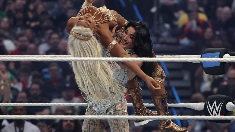 Rhea Ripley hoists up Jade Cargill in the Razor's Edge.