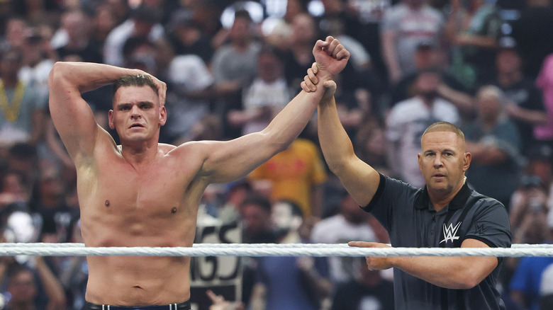 Gunther's hand is raised in victory