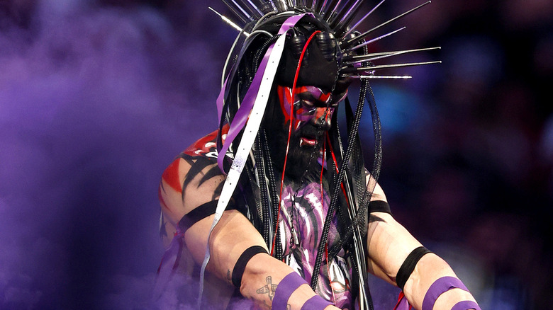 "The Demon" Finn Balor makes his entrance bathed in purple smoke.