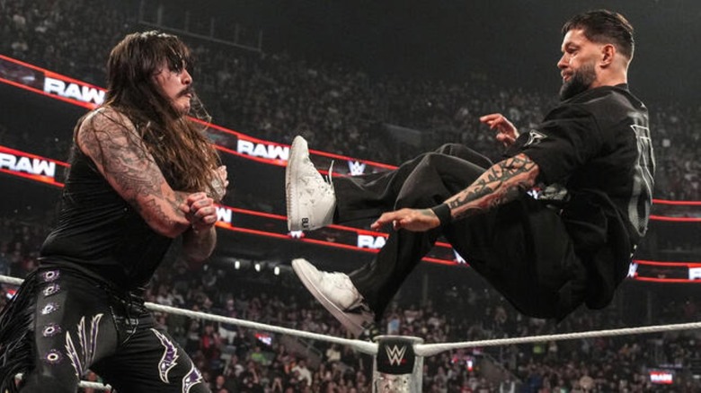 Finn Balor dropkicks Dominik Mysterio