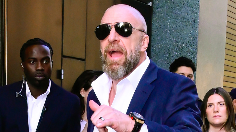 Triple H staring into the flash of a photographer's camera