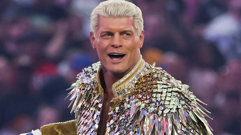 Cody Rhodes wearing a gold ring jacket