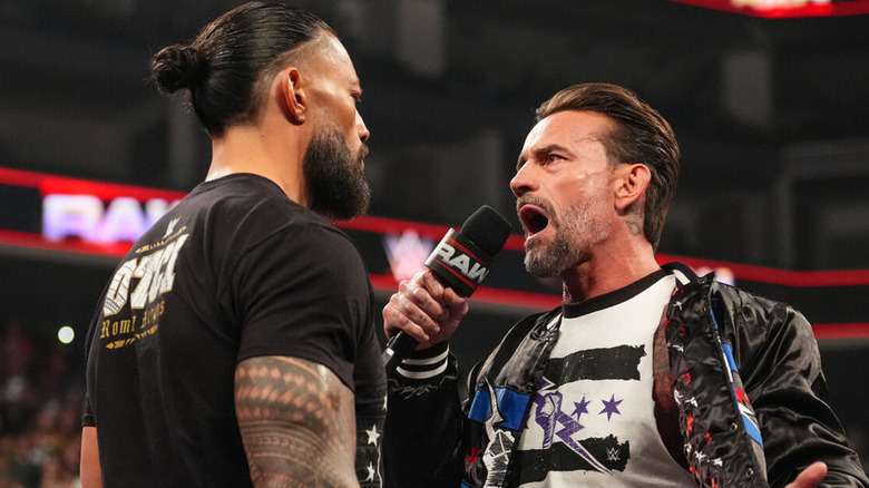 CM Punk and Roman Reigns staring off