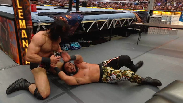 McIntyre with the staple gun on the outside about to use it on Fatu