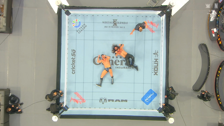 GUNTHER and Rollins both down in the ring