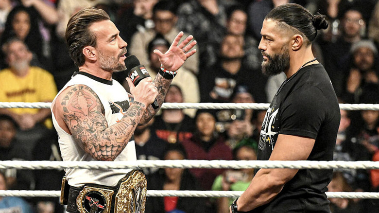 Punk and Reigns talking in the ring