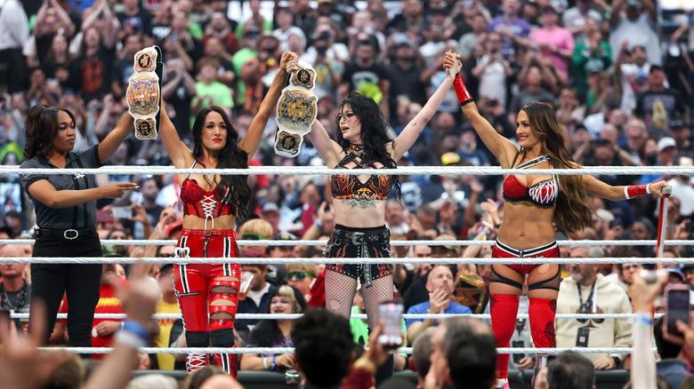 Brie Bella, Paige and Nikki Bella celebrate after Brie Bella and her partner Paige, competing for the injured Nikki Bella, won the WWE Women's Tag-Team Championship Fatal 4-Way match against Nia Jax, Lash Legend, Charlotte Flair, Alexa Bliss, Bayley and Lyra Valkyria during WrestleMania 42 at Allegiant Stadium on April 18, 2026 in Las Vegas, Nevada.