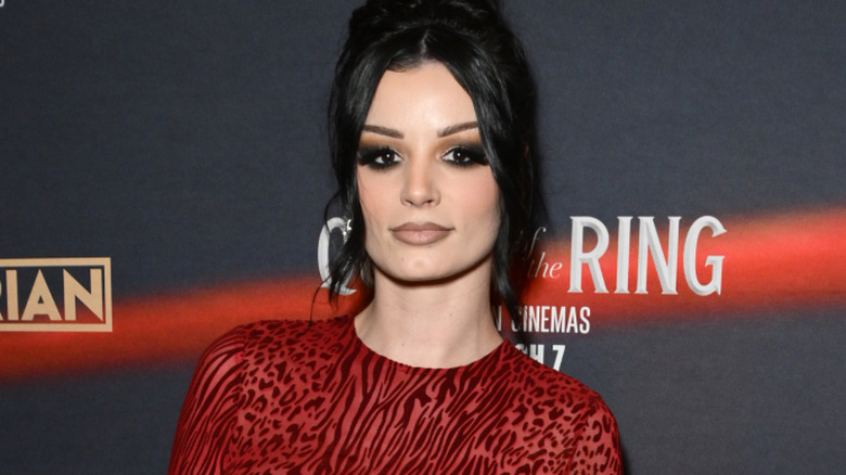 Paige wearing a red dress