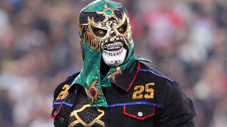 Penta wearing a green mask